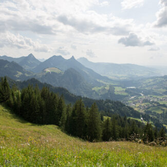 Vue panoramique depuis le sommet de Charmey sur les Préalpes fribourgeoises, dévoilant un paysage montagneux